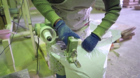 The Stitching Of The Bag With Potato Flour Factory.