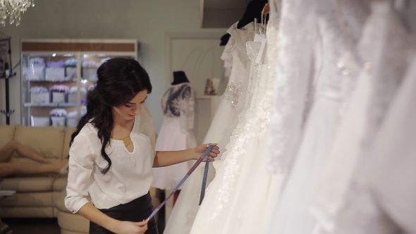 Young Salesman Bridal Salon Chooses Dress For The Bride