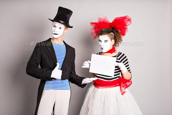 Your text here. Actors mimes holding empty blank board.