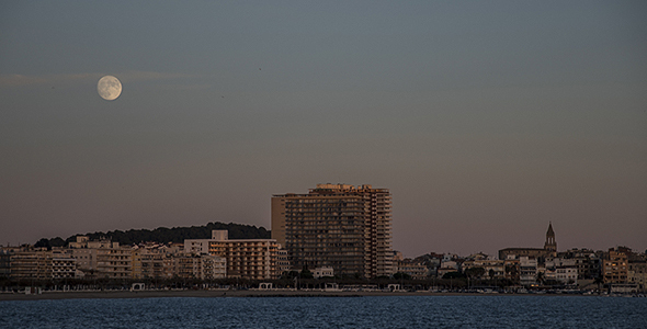 Rising Full Moon over a Sea Town