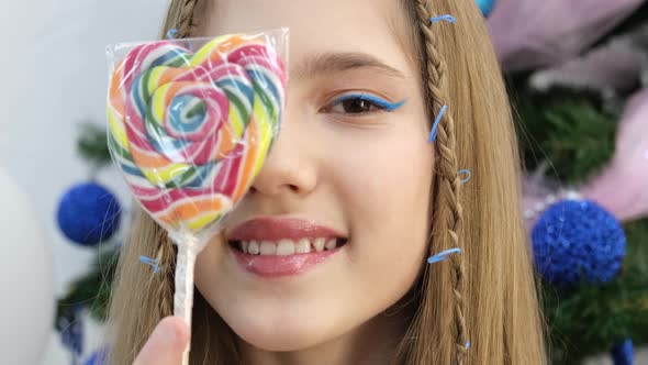 Portrait of Teenage Girl with Lollipop on Stick Close Up alt