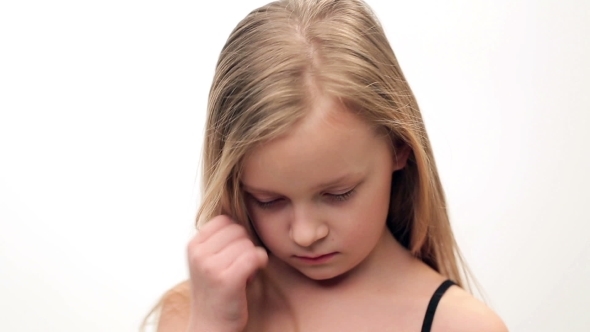 Little Girl With Blond Hair Shows Sadness, Sorrow.