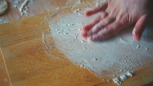 Woman Hand Throwing Flour On The Table