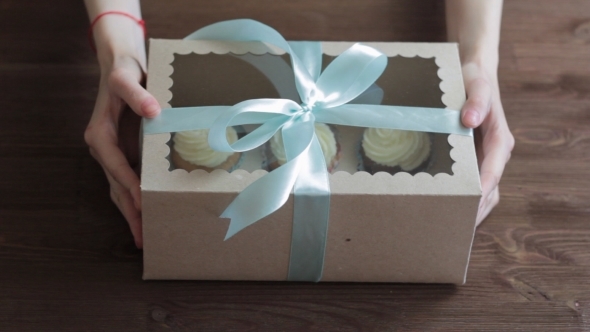 Decorative Gift Box Tied With Cupcakes a Turquoise Ribbon In Female Hands