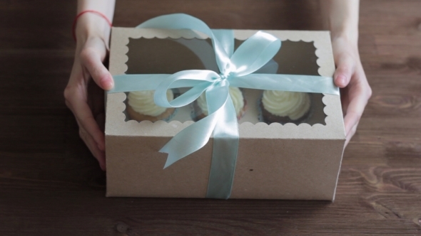 Decorative Gift Box Tied With Cupcakes a Turquoise Ribbon In Female Hands