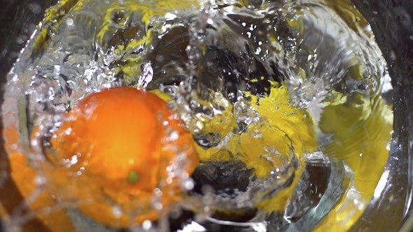 Lemons And Orange Falling Into Water