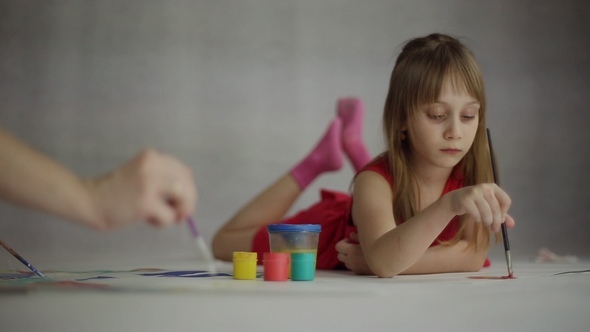 The Girl Draws on a Sheet of Paper alt