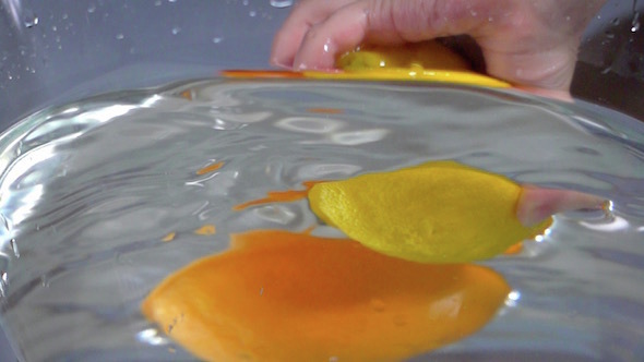 Hand Making Orange And Lemon Water