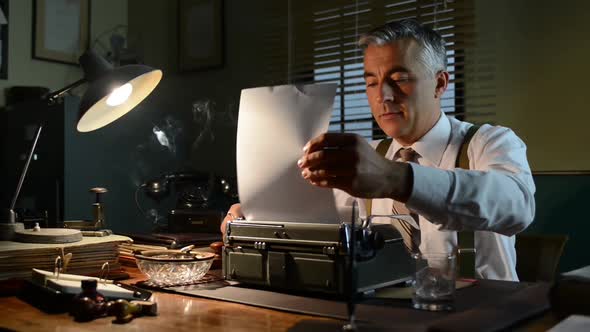 Office worker inserting paper in the typewriter