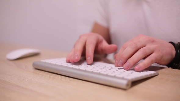 Man Typing On White Keyboard