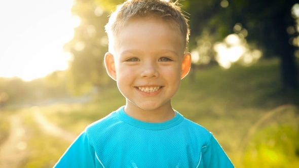 Portrait Of Smiling Boy On Sunset alt