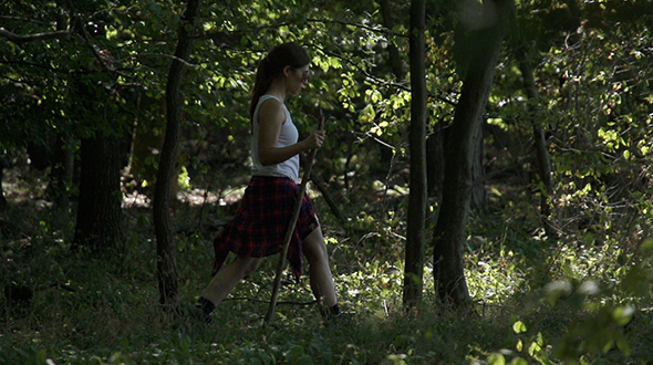 Woman walking through forest