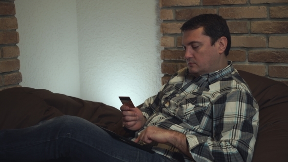 Attractive Man Making Credit Card Purchases. alt