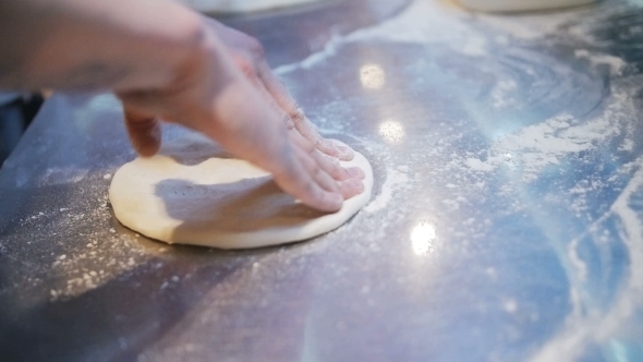 Chef Kneading The Dough On The Metal Table Full Of Flour