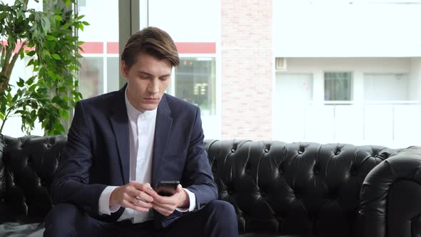 Professional Creative Man Sitting in Home Office Studio Using Smartphone, Man Using Mobile  alt