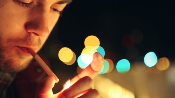 Male Lighting Up A Cigarette -Shot