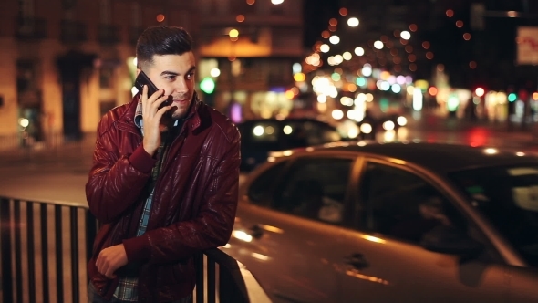 Young Man Calling On Mobile Phone At Night In City.