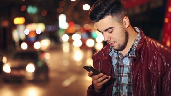 Man Sms Texting Using App On Smart Phone At Night In City
