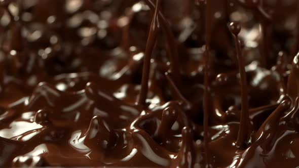 Super Slow Motion Detail Shot of Splashing Melted Chocolate at 1000 Fps alt