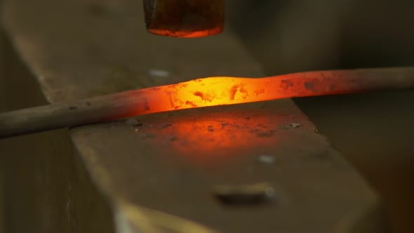 Blacksmith Forges The Metal On The Anvil