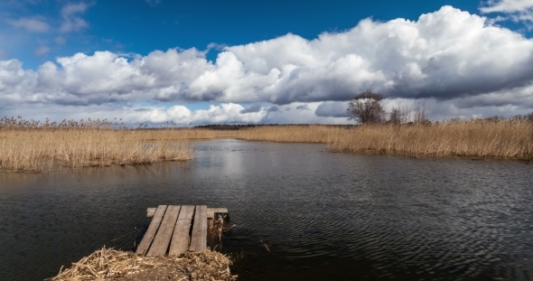 Lake With Pier And Clouds alt