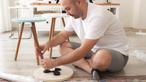 young man doing self-assembly at home. home decor and design