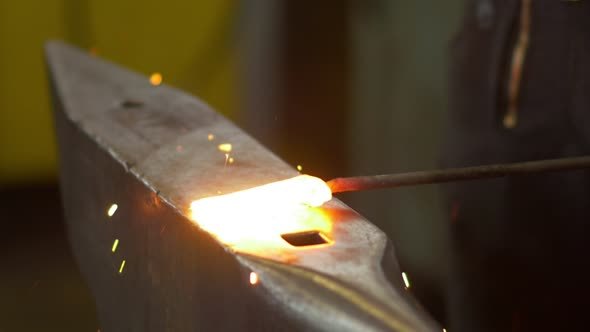 Blacksmith Forging The Molten Metal On The Anvil