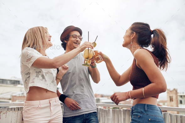 Young people enjoying cocktails at a party