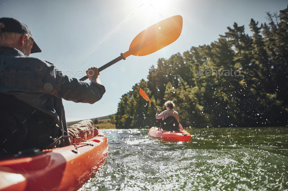 Senior couple kayaking in a lake