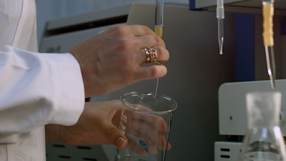 Researcher Take Sample Liquid in Flask