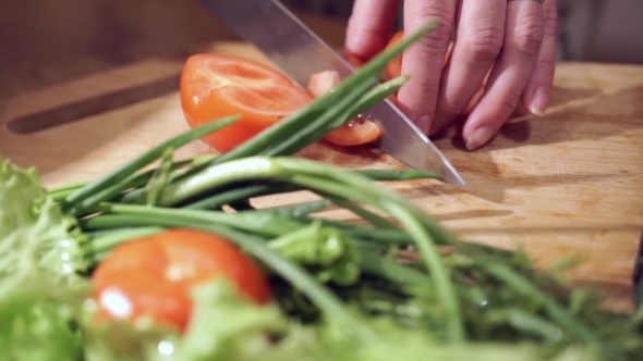 Cooking And Home Concept. Cutting Tomato.