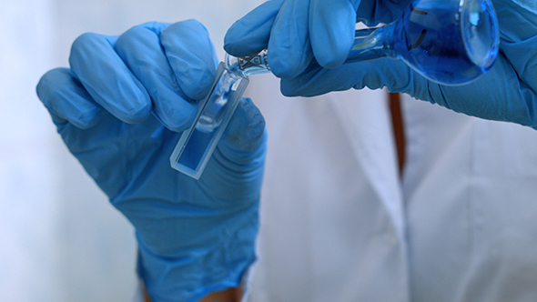 Scientist Take Sample Liquid in Flask