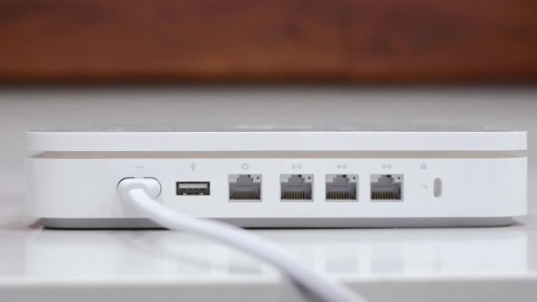 Hand Plug In  Ethernet Cable In White Router alt