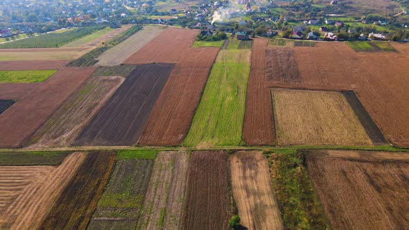 Ukrainian fields stretch on the hills near the settlements Aerial view