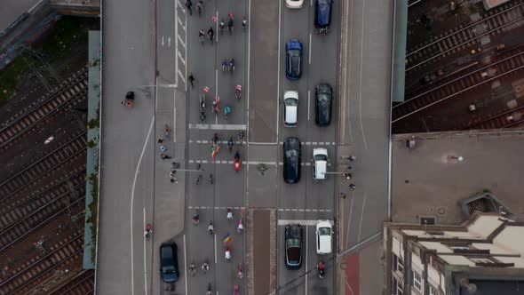 Aerial Birds Eye Overhead Top Down Panning View of Large Group of Cyclists Participating on alt