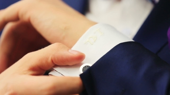 Stylish Groom In Blue Luxury Suit Wearing Cufflinks 