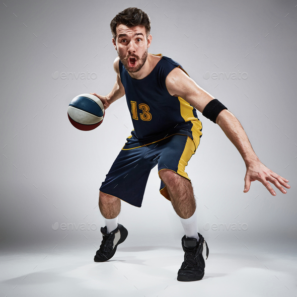 Full length portrait of a basketball player with ball - Stock Photo - Images