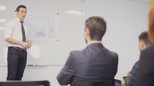 Businessman Presenting To The Team Taking Notes In The Boardroom alt