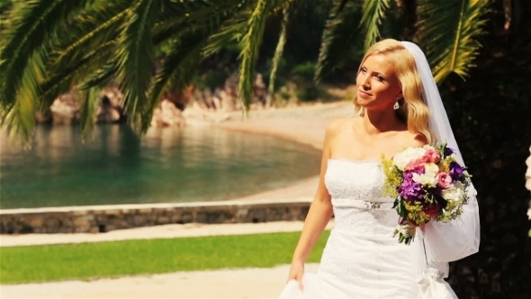 Charming Blond Bride Walking With Flowers On Montenegro