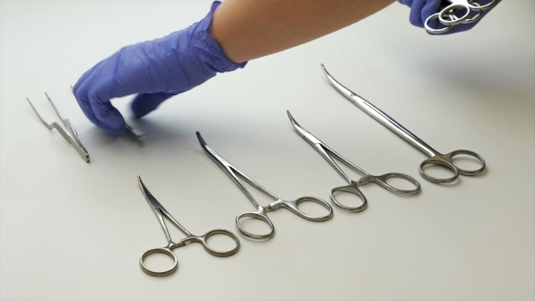 Surgical Nurse Picks Medical Tools Up In Surgery 