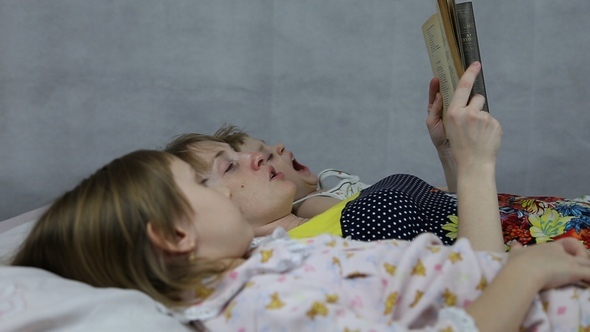 Mom Reading the Book to Son and Daughter Bedtime alt