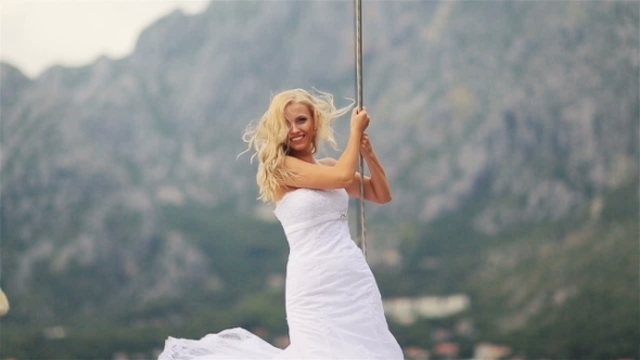 Charming Blond Bride Posing  At The Stern Of Vintage Yacht Sailing On The Sea In Montenegro, Budva