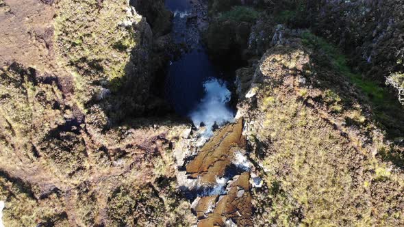 A flight over a waterfall in the scottish highlands along the nc500 route alt