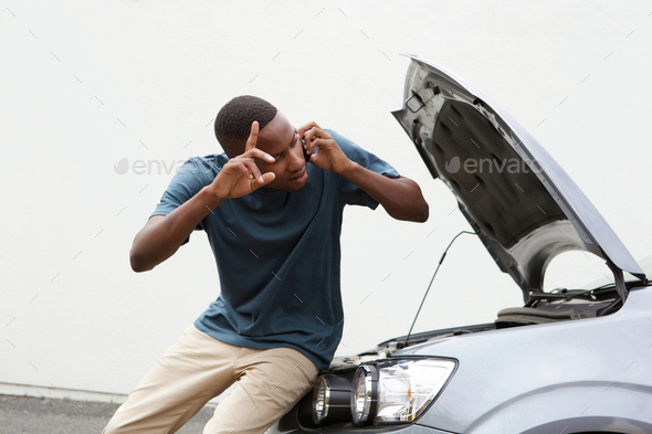 Young Guy Calls For Help With By Broken Down Car Young Guy Calls For Help With By Broken Down Car
