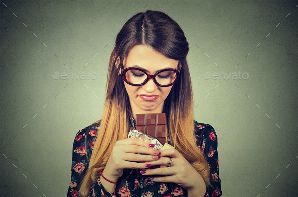 young woman tired of diet restrictions craving sweets chocolate