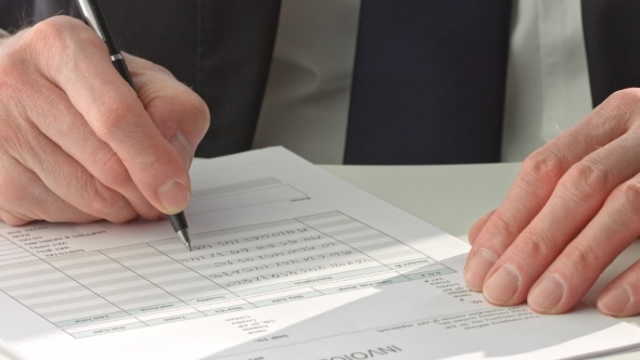 Businessman In Suit Signing a Document alt