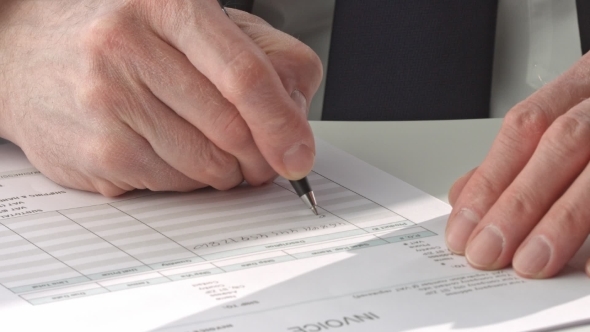 Male Hand In Suit Filling In Invoice Paper