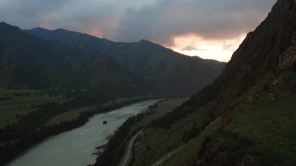 Katun river and road in valley of Altai at sunset time with dramatic sky