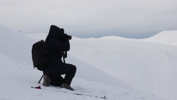 Woman Taking Landscape Shot in Winter Mountains.