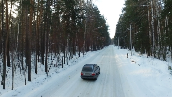 Flight Of The Car In The Woods. Car On Forest Road. Winter